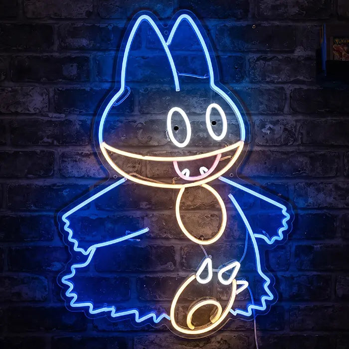 Pokémon Mampfaxo Neon LED Schild an einer Backsteinwand, blaue Kontur mit geöffnetem Maul und hellem Bauchlatz