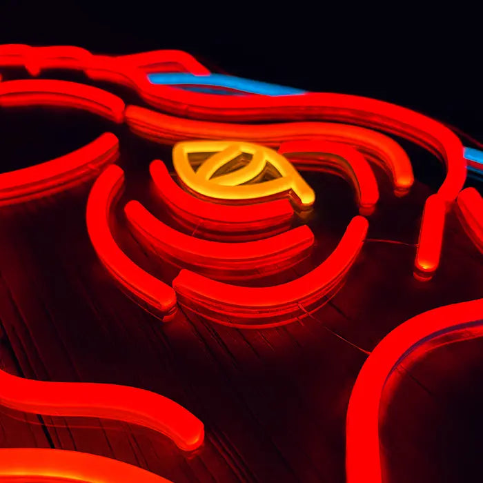 T-Rex Dino Neon LED Schild in Makroaufnahme, gelbes Auge zwischen roten Neonlinien