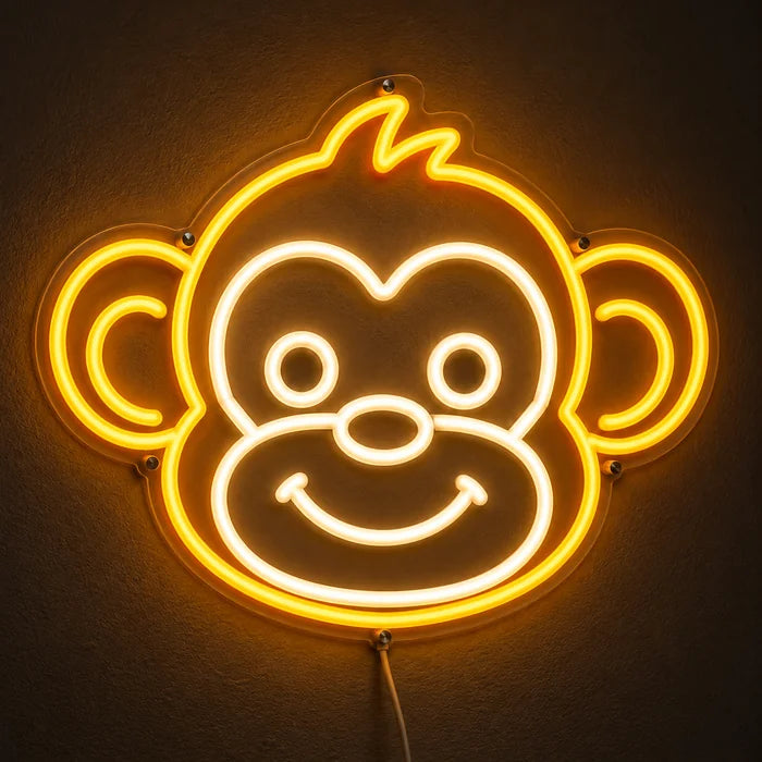 Affengesicht Neon LED Schild leuchtend an einer dunklen Wand, Nahaufnahme mit Anschlusskabel