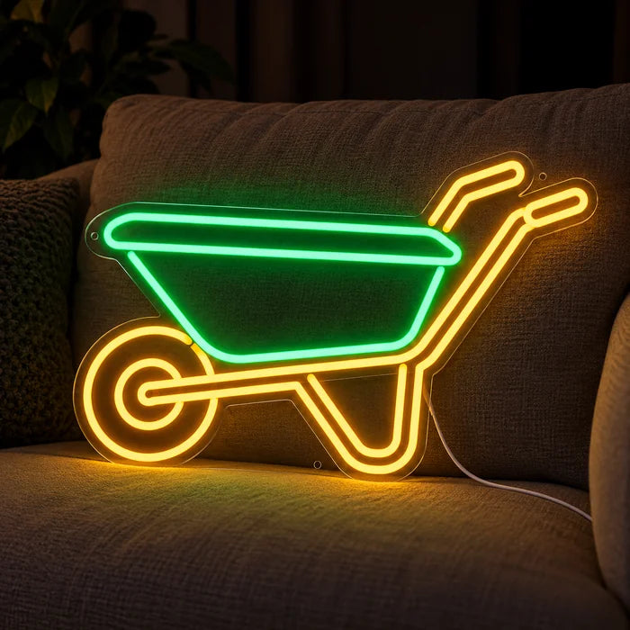 Schubkarre Neon LED Schild auf einem gemütlichen Sofa zwischen Kissen und Decke