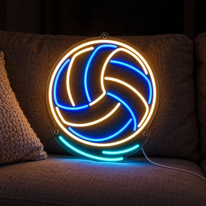 Volleyball Neon LED Schild auf einem gemütlichen Sofa zwischen Kissen und Decke