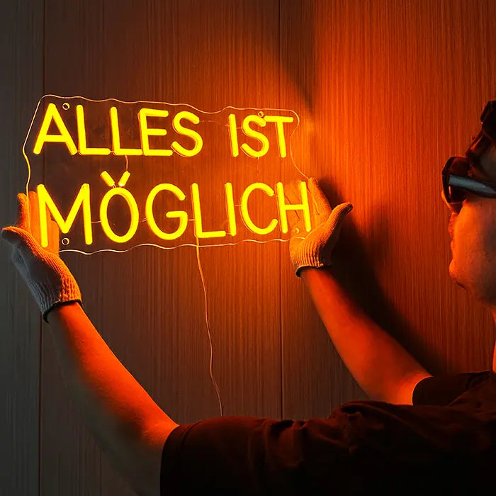 Alles Ist Möglich Neon LED Schild wird mit Handschuhen an der Wand ausgerichtet