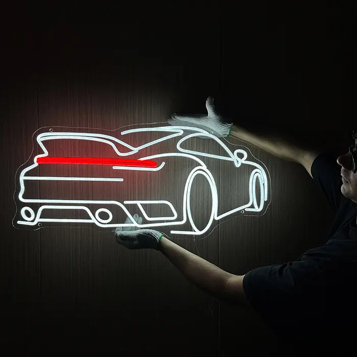 GT-Sportwagen Neon LED Schild wird mit Handschuhen an eine dunkle Wand gehalten
