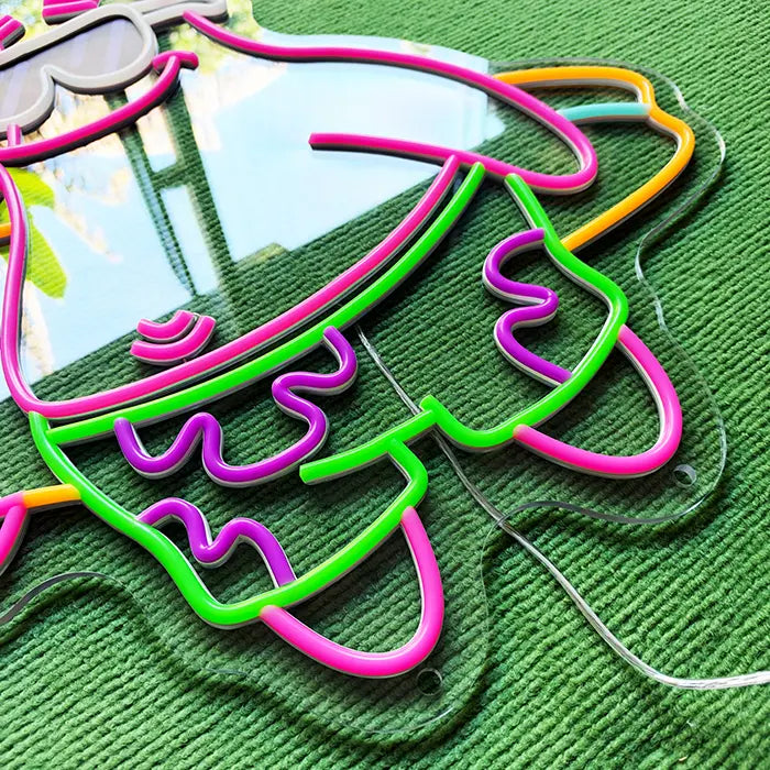 Patrick Surfer Neon LED Schild ausgeschaltet, Detail von Badeshorts und Surfbrett auf dem Acrylglas