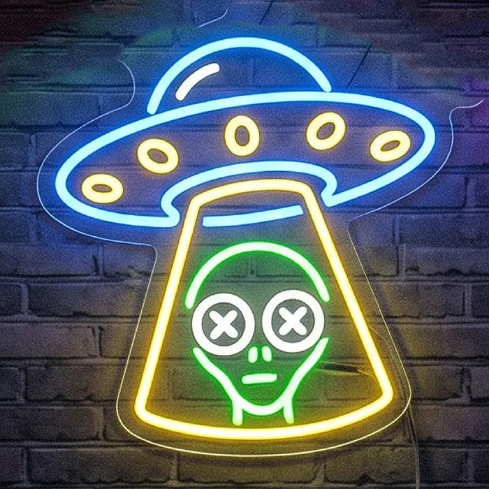 UFO Alien Entführung Neon LED Schild an einer Backsteinwand, Alien mit weißen X-Augen im gelben Traktorstrahl