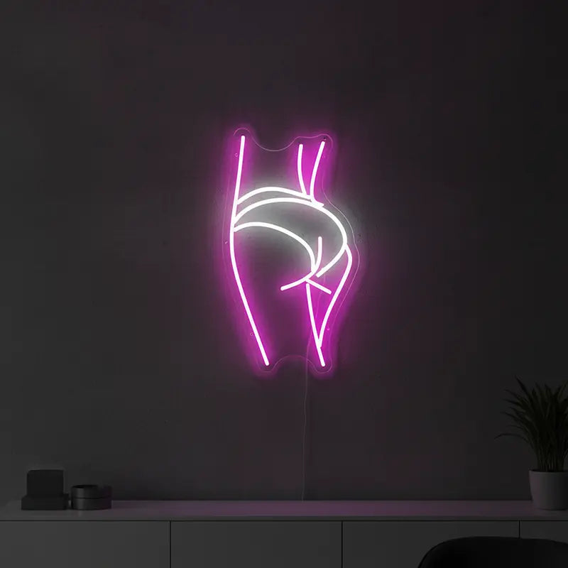 Custom-Neon-Sign einer weiblichen Figur mit hochgezogenen Armen, beleuchtet in Pink als moderne Wanddeko.
