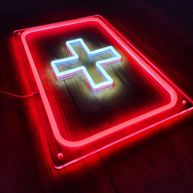 Neon-Symbol für Rettungsdienst oder Apotheke, mit einem dicken, weißen Kreuz und einem hellroten Leucht-Rechteck.