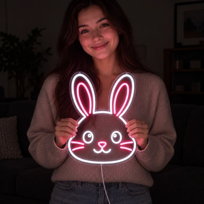 Hasengesicht Neon LED Schild in den Händen einer lächelnden Frau vor dunklem Hintergrund