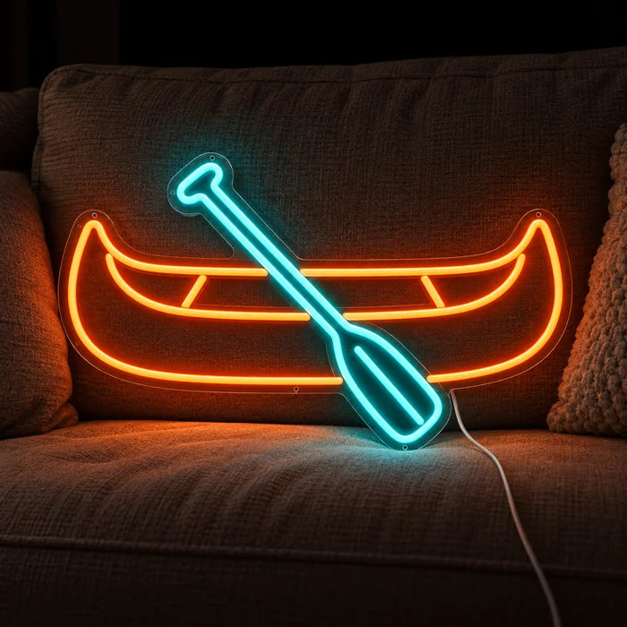 Kanu Neon LED Schild auf einem gemütlichen Sofa zwischen Kissen und Decke