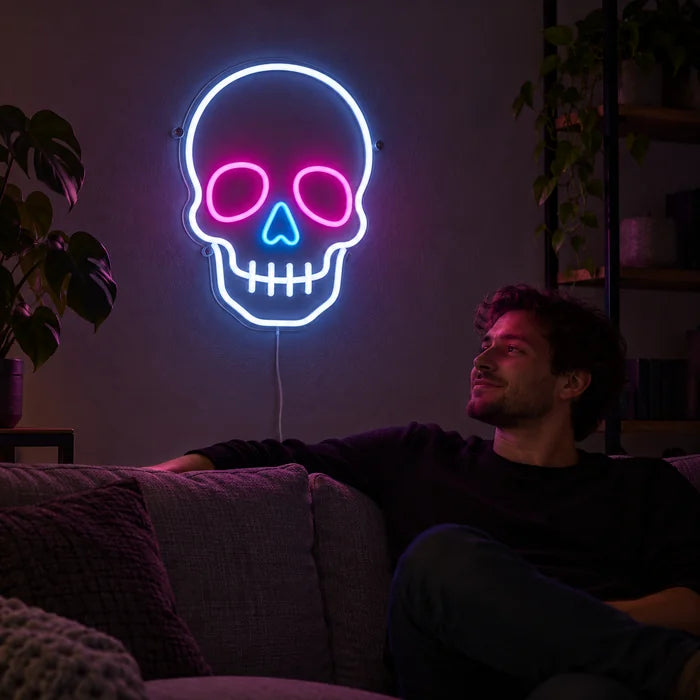 Neon-Schädel Neon LED Schild an der Wohnzimmerwand, davor entspannt eine Person auf dem Sofa
