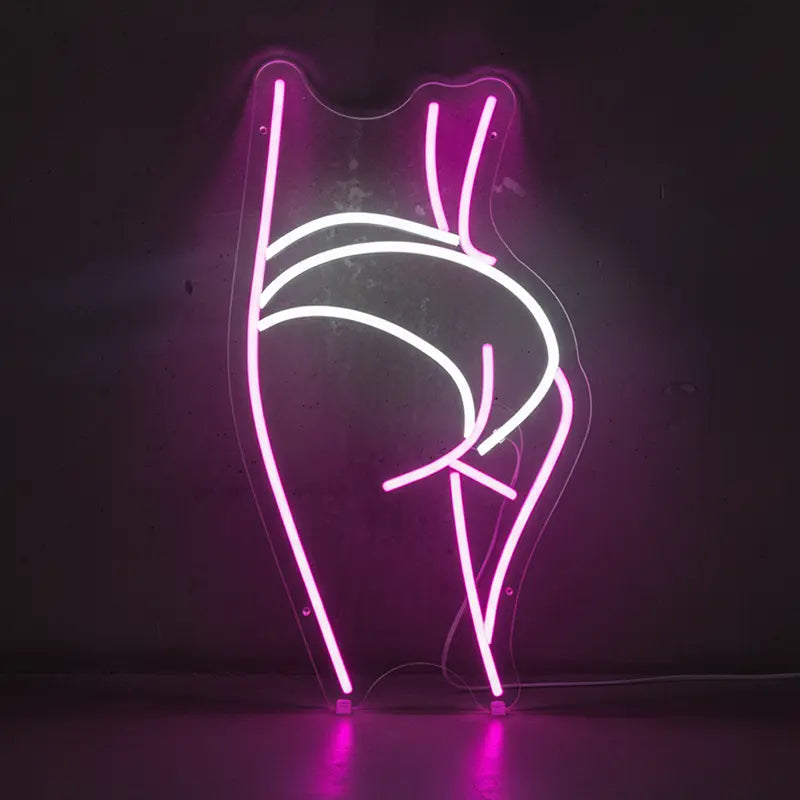 Neon-Schild als stilisierte, weibliche Silhouette in Pink und Weiß, die von hinten posiert.
