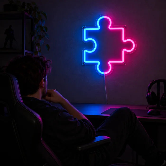 Puzzleteil Neon LED Schild über dem Gaming-Schreibtisch, davor ein Spieler im Gaming-Stuhl