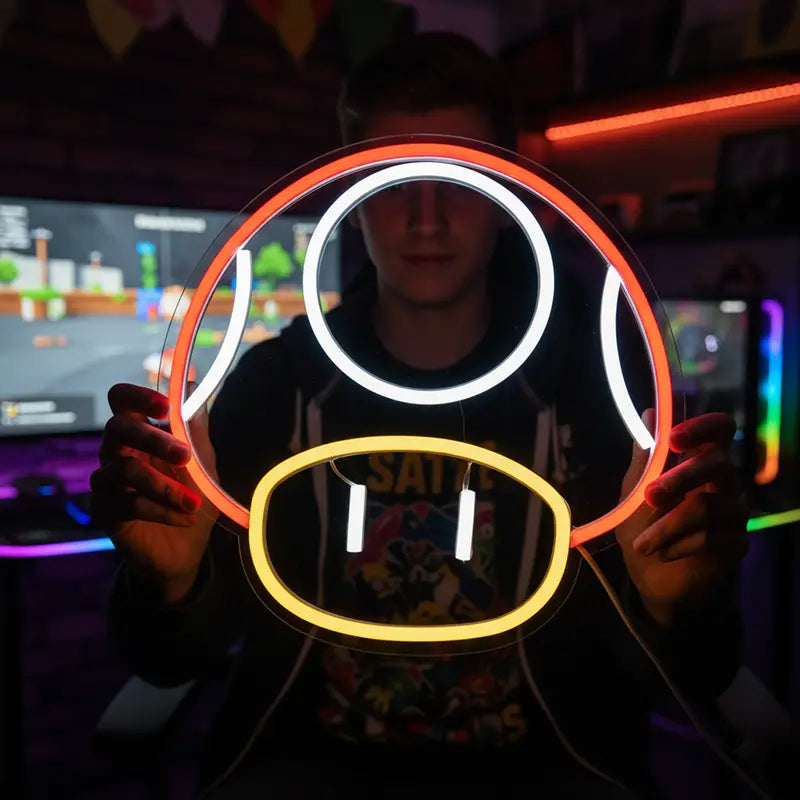 Runder Neon-Pilz mit rotem Rand, weißen Flecken und gelbem Fuß; eine beliebte Figur aus Videospielen.
