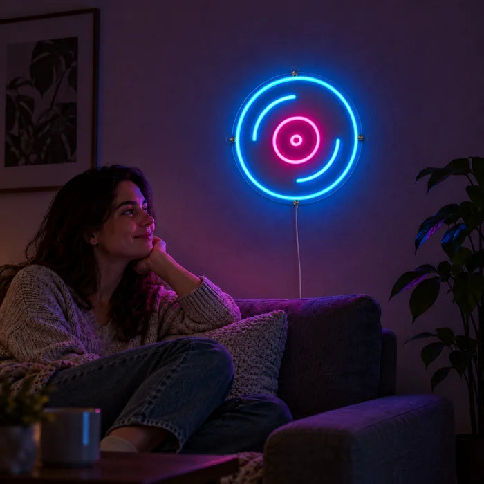 Schallplatte Neon LED Schild an der Wohnzimmerwand, davor entspannt eine Person auf dem Sofa
