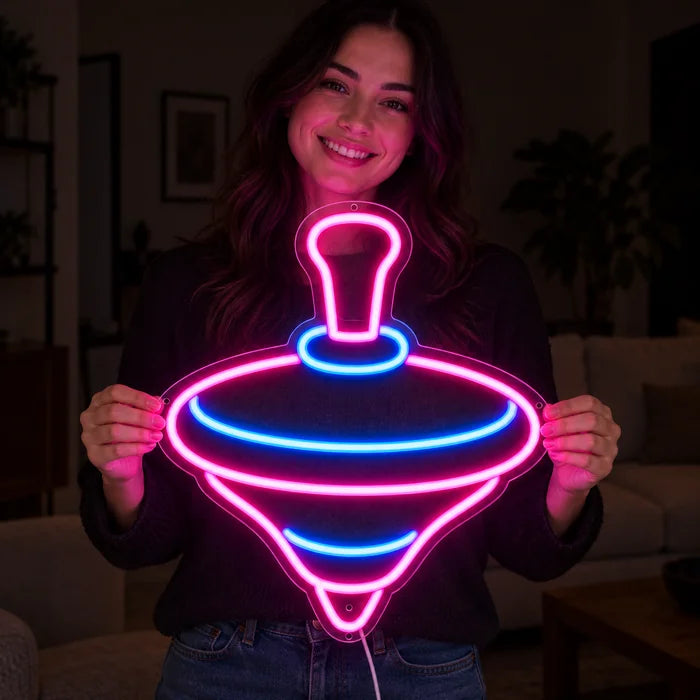 Spielkreisel Neon LED Schild in den Händen einer lächelnden Frau vor dunklem Hintergrund