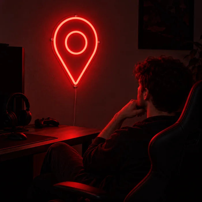 Standortmarker Neon LED Schild über dem Gaming-Schreibtisch, davor ein Spieler im Gaming-Stuhl