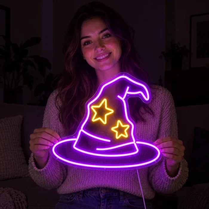 Zauberhut Neon LED Schild in den Händen einer lächelnden Frau vor dunklem Hintergrund